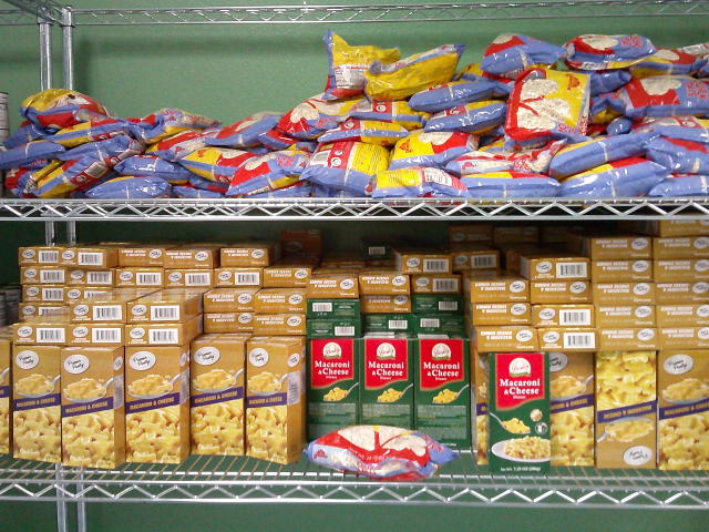 Bags of oats on the top shelf and boxes of mac n cheese on the middle shelf.